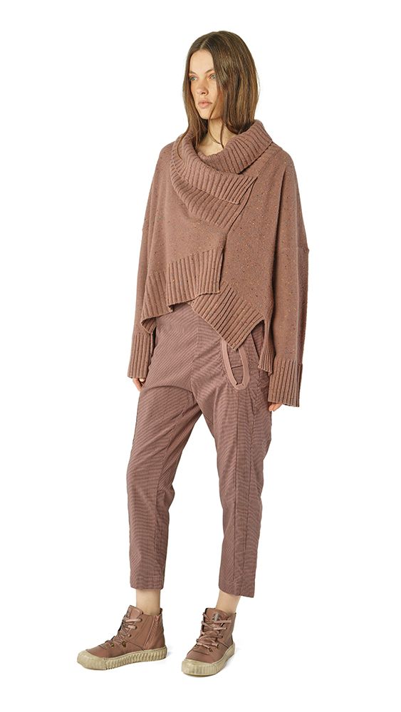 Frau trägt oversized taubenfarbenen Pullover mit weitem Rock und bequemen Schuhen.