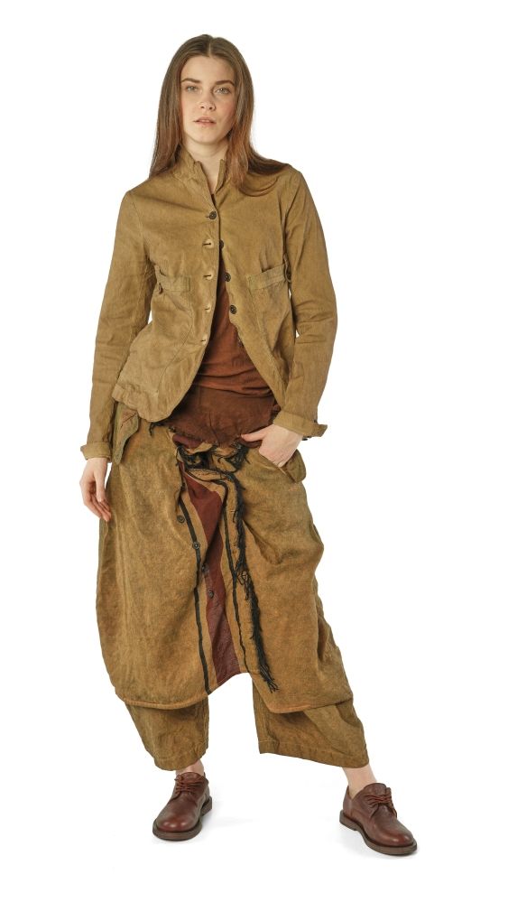 Person trägt oversized braune Jacke mit weitem Hosenrock und braunen Stiefeln, elegant-vintage Stil.
