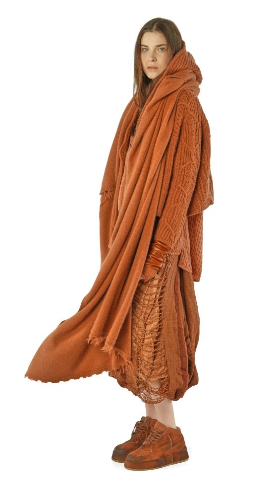 Frau trägt oversized braunen Schal mit weitem Rock und robusten Stiefeln.